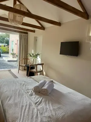 a bedroom with a bed with two towels on it at Huisje Marie in Zandvoort