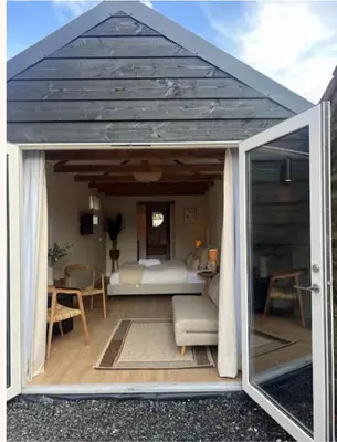 a room with a roof with a bed in it at Huisje Marie in Zandvoort