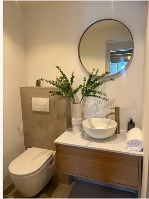 a bathroom with a sink and a toilet and a mirror at Huisje Marie in Zandvoort