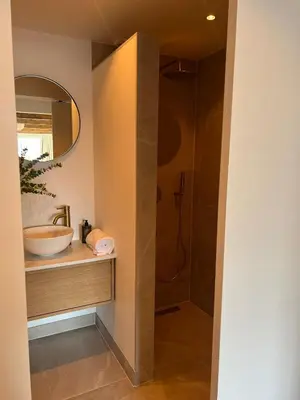 a bathroom with a sink and a shower at Huisje Marie in Zandvoort
