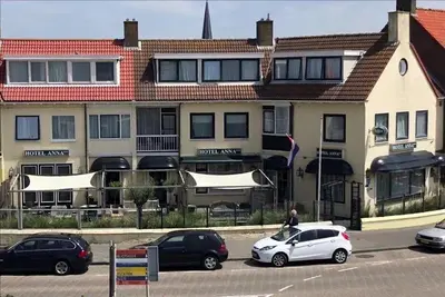 a group of cars parked in front of a building at Hotel Anna in Zandvoort