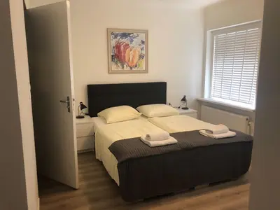 a bedroom with a bed with two towels on it at Hotel Anna in Zandvoort