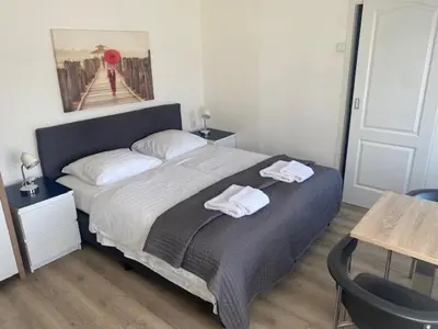 a bedroom with a bed with two towels on it at Hotel Anna in Zandvoort