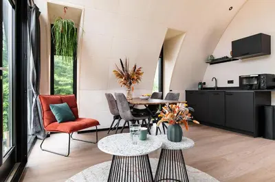 a kitchen and living room with a table and chairs at GreenFloat Boskoop #2 in Boskoop