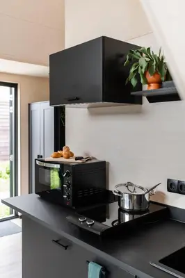 a kitchen with a counter top with a microwave at GreenFloat Boskoop #2 in Boskoop
