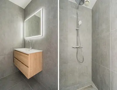 a bathroom with a shower with a sink and a mirror at Molenzicht in Alkmaar