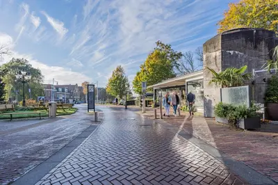 a cobblestone street with people walking down it at Molenzicht in Alkmaar