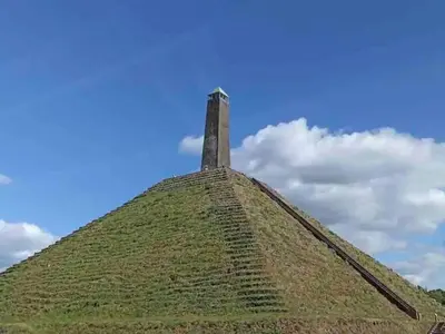 a tower on top of a grass covered hill at Scilla in Soesterberg