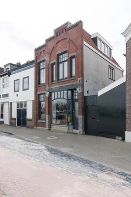 an empty street with a brick building at Pakhuis aan de Zaan in Wormerveer