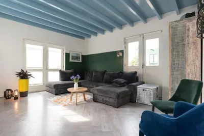 a living room with a couch and a table at Pakhuis aan de Zaan in Wormerveer