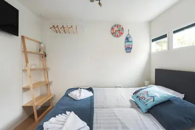 a bedroom with a bed with two pillows on it at Milis Beach Cottage in Zandvoort