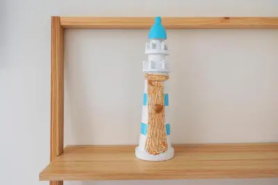 a lighthouse bottle sitting on a shelf at Milis Beach Cottage in Zandvoort