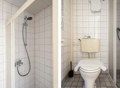 a bathroom with a toilet and a shower at Milis Beach Cottage in Zandvoort