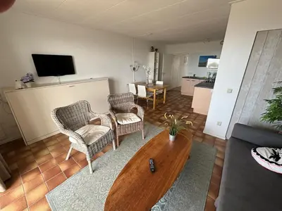 a living room with a couch and chairs and a table at Villa aan Zee in Noordwijk