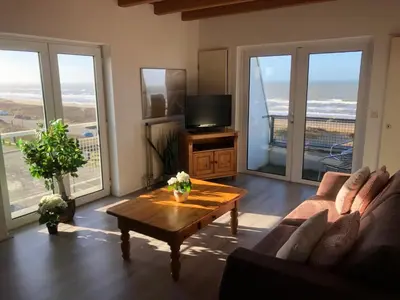 a living room with a couch and a coffee table at Villa aan Zee in Noordwijk