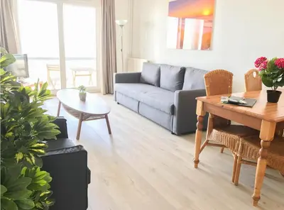 a living room with a couch and a table at Villa aan Zee in Noordwijk