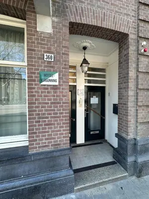 a front door of a brick building with a sign on it at Marnix360apartments The Mansion Suites in Amsterdam
