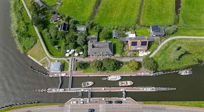 an aerial view of an estate with boats in the water at Aan de Amstel in De Kwakel