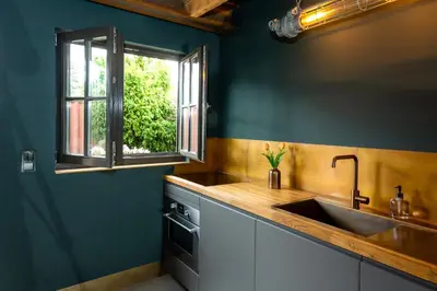 a kitchen with a sink and a window at De koperslager in Watergang