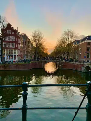 a view of a river with a bridge and buildings at Het Oude Raadhuis in Noordwijkerhout