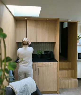 a woman is standing in a kitchen at Het Oude Raadhuis in Noordwijkerhout
