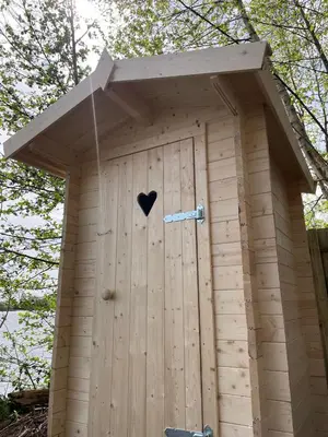 a out house with a heart on the door at Luxury Experience in Off The Grid Lodge at an Amazing Lake Vinkeveense Plassen in Vinkeveen