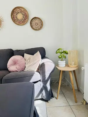 a living room with a couch and a table at Hello Noordwijk - Tiny house Julianastraat 12 in Noordwijk aan Zee