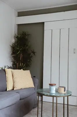 a living room with a couch and a table at Charley's Beachhouse in Noordwijk aan Zee