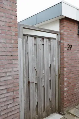 a wooden garage door with the number on it at Charley's Beachhouse in Noordwijk aan Zee