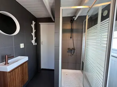 a bathroom with a shower and a sink at New- The Cabana- With Sauna and Hot Tub, on a lake near Amsterdam in Vinkeveen
