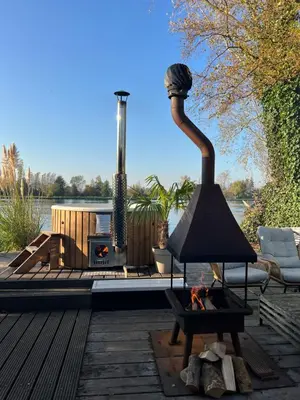a living room with a fireplace and a fire place at New- The Cabana- With Sauna and Hot Tub, on a lake near Amsterdam in Vinkeveen