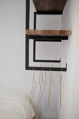 a mirror hanging on a wall next to a bed at Beach Lodge 24 - Noordwijk aan Zee - met eigen tuin in Noordwijk