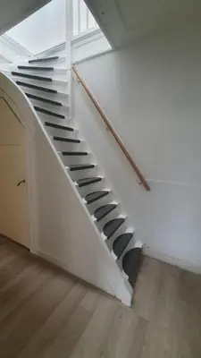 a white staircase with black treads in a house at Apartment City Center Terrace with Iconic View in Gouda