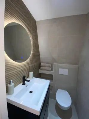 a bathroom with a white sink and a toilet at Apartment City Center Terrace with Iconic View in Gouda
