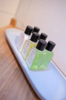 a group of four bottles of soap on a surfboard at Kuwadro Guesthouse Jordaan in Amsterdam
