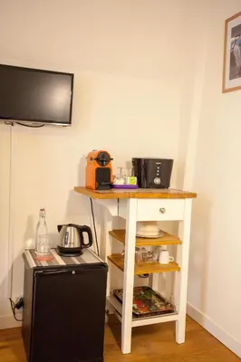 a small table in a room with a microwave at Kuwadro Guesthouse Jordaan in Amsterdam