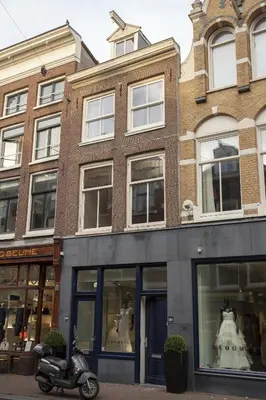 a scooter parked in front of a building at Kuwadro Guesthouse Jordaan in Amsterdam
