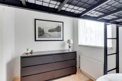 a bedroom with a chest of drawers and a window at Meerzicht 59 - Ideal family appt for 6 persons in Uitgeest