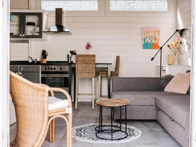 a living room with a couch and a table at Rosa's Cottage, garden and free parking in Zandvoort