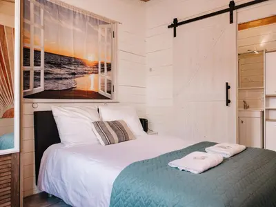 a bedroom with a bed with two towels on it at Rosa's Cottage, garden and free parking in Zandvoort