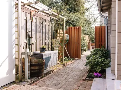 a garden with a pergola on a house at Rosa's Cottage, garden and free parking in Zandvoort