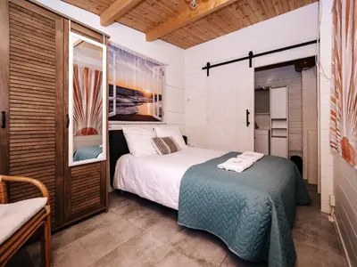 a bedroom with a bed and a window at Rosa's Cottage, garden and free parking in Zandvoort
