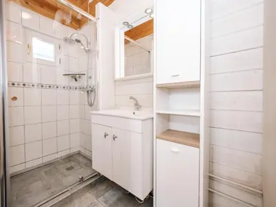 a bathroom with a sink and a shower at Rosa's Cottage, garden and free parking in Zandvoort