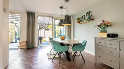 a kitchen with a table and chairs in a room at Casa Mimi in Bergen