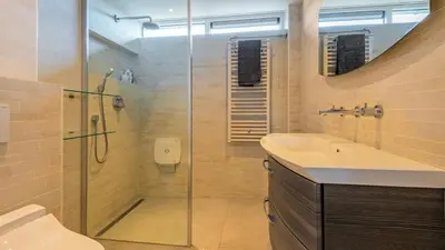 a bathroom with a shower and a sink at Casa Mimi in Bergen