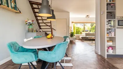 a dining room with a table and blue chairs at Casa Mimi in Bergen