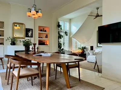 a kitchen and living room with a wooden table and chairs at WS77 B&B Apartment in Leiden