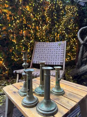 a wooden table with four metal cylinders on it at WS77 B&B Apartment in Leiden