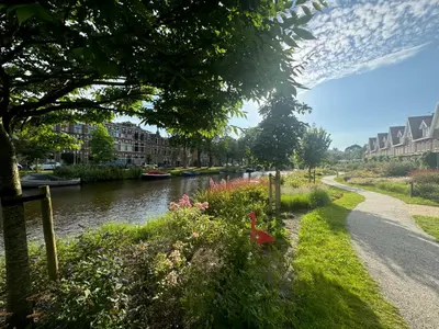a river with flowers on the side of a road at WS77 B&B Apartment in Leiden