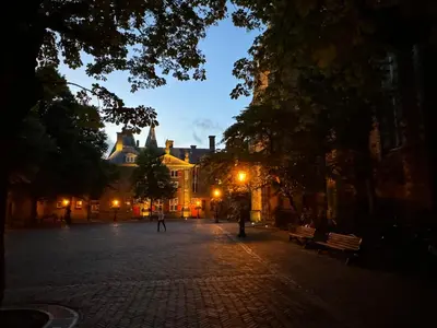 a cobblestone street at night with a building at WS77 B&B Apartment in Leiden